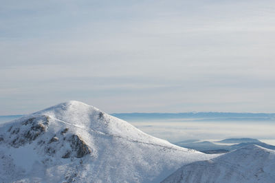 Scenic view of snowcapped mont sancy mountain against sky in auvergne france