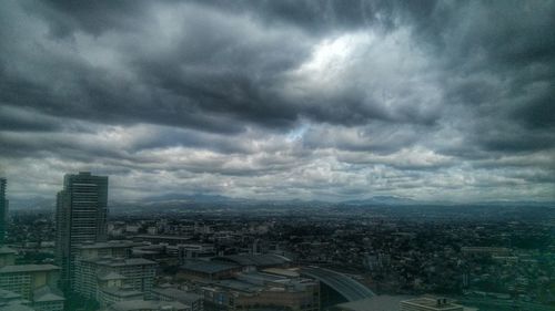 Cityscape against cloudy sky