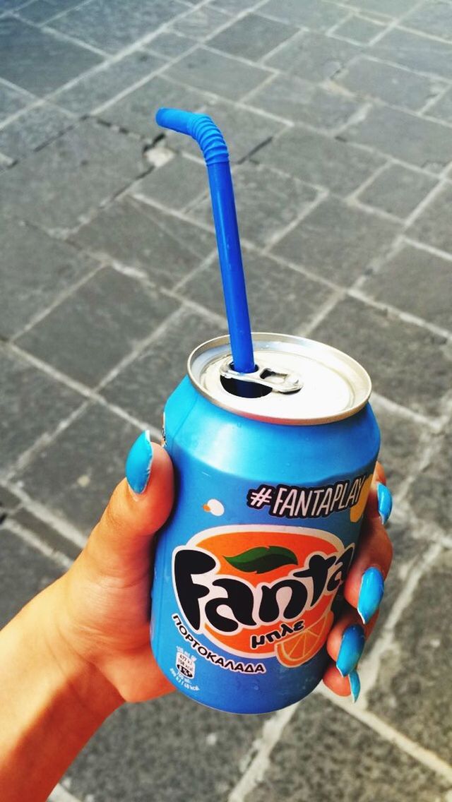 holding, high angle view, blue, street, person, part of, day, personal perspective, close-up, outdoors, unrecognizable person, cropped, sunlight, plastic, food and drink, childhood, sidewalk