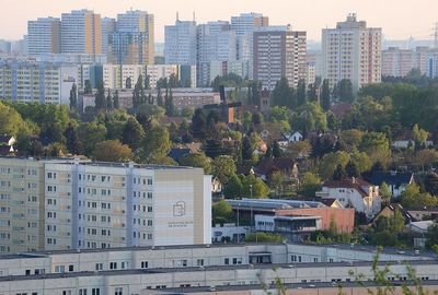 High angle view of buildings and trees in city