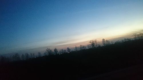 Silhouette trees against sky during sunset