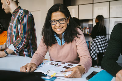 Portrait of smiling mature female student studying at university