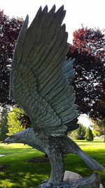 Close-up of statue in park against sky