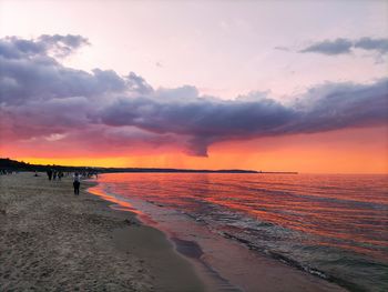 Scenic view of beach against sky during sunset