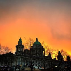 Low angle view of building against sunset sky