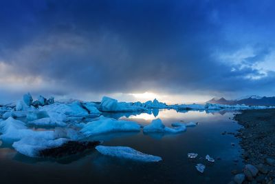 Frozen lake against sky during winter