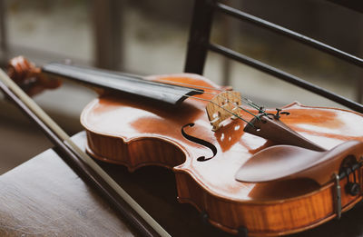 Close-up of violin on chair