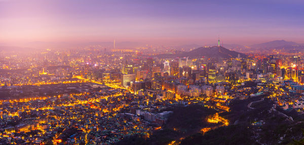 Illuminated cityscape against sky