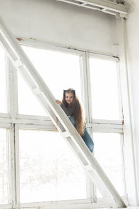 Low angle view of young woman standing in building