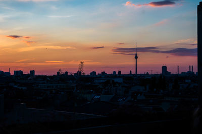 View of cityscape against cloudy sky during sunset