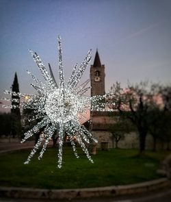 Illuminated christmas tree against sky at night