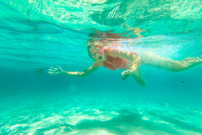 Close-up of young woman swimming in sea