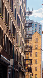 Low angle view of buildings in city against sky