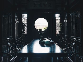 Empty chairs and tables in building