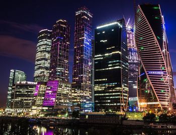 Low angle view of modern buildings against sky at night