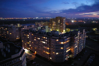 High angle view of illuminated buildings in city at night