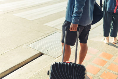 Low section of people walking on street