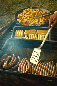 Person preparing food on barbecue grill