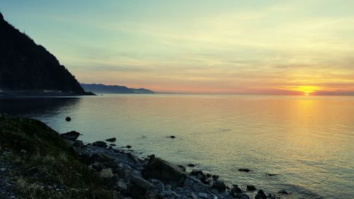 Scenic view of sea against sky at sunset