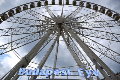 Low angle view of ferris wheel against sky