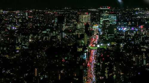 Aerial view of illuminated city buildings at night