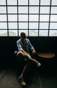 Man sitting by window at home