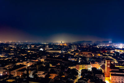 High angle shot of illuminated cityscape against sky at night