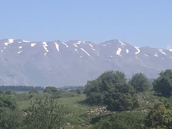 Scenic view of snowcapped mountains against clear sky