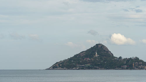 Scenic view of sea and mountains against sky