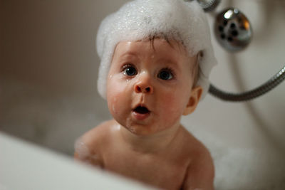 Portrait of cute baby girl in bathroom