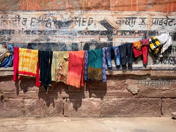 Clothes drying on clothesline against wall