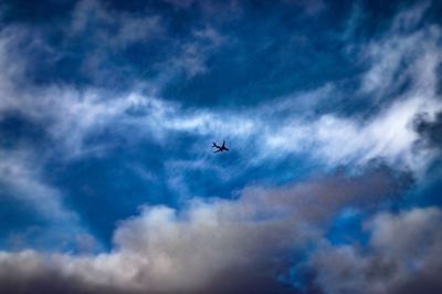 Low angle view of airplane flying in sky