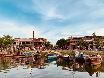 Boats moored in canal against buildings