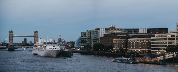 Boats in river with buildings in background