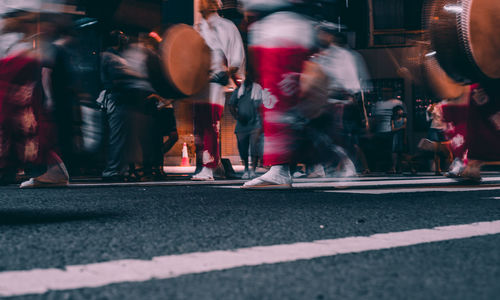 Blurred motion of people walking on street in city