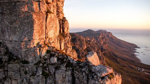 Scenic view of rock formations against sky during sunset