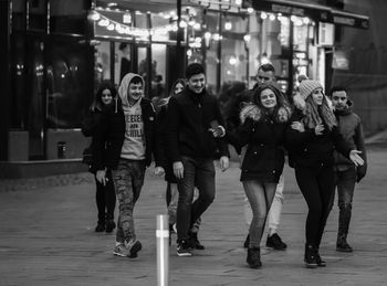 Portrait of people walking on street at night