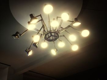 Low angle view of electric lamp hanging on ceiling