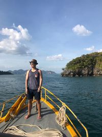 Full length of young man on sea against sky