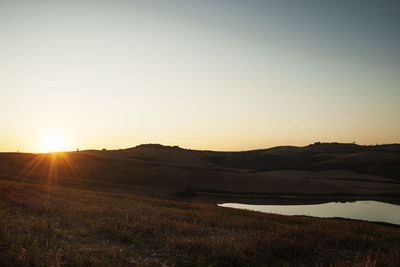 Scenic view of field against sky during sunset