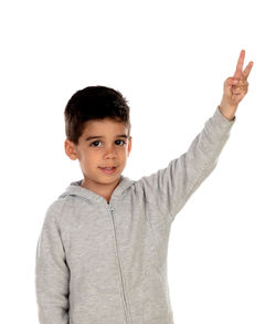 Portrait of boy standing against white background