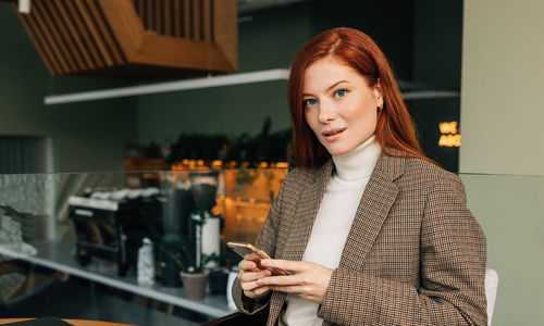 Portrait of young woman using mobile phone