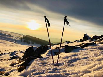 Scenic view of frozen lake against sky during sunset