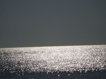 Scenic view of sea against clear sky at night