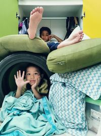 Full length portrait of cute siblings playing a fort