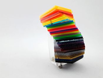 Stack of multi colored pencils on white background