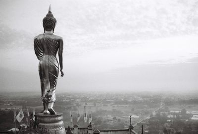 Close-up of statue against cityscape