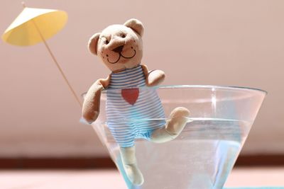 Close-up of stuffed toy in drink on table