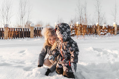 Girl standing on snow field during winter