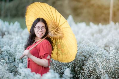 Portrait of a smiling young woman standing outdoors